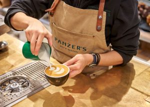 Barista pouring a latte