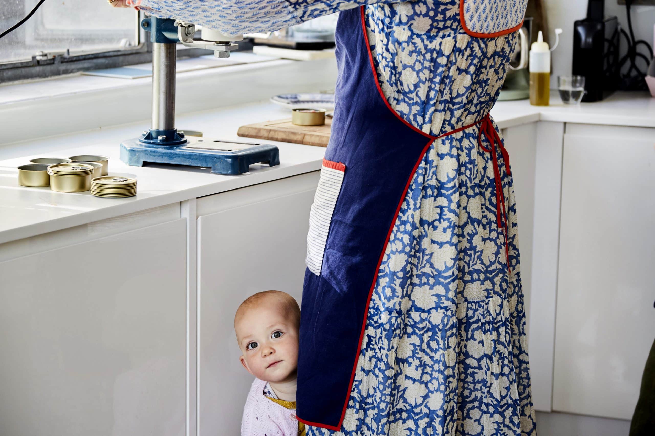 Daughter of Sea Sisters founders peeks out from behind an apron