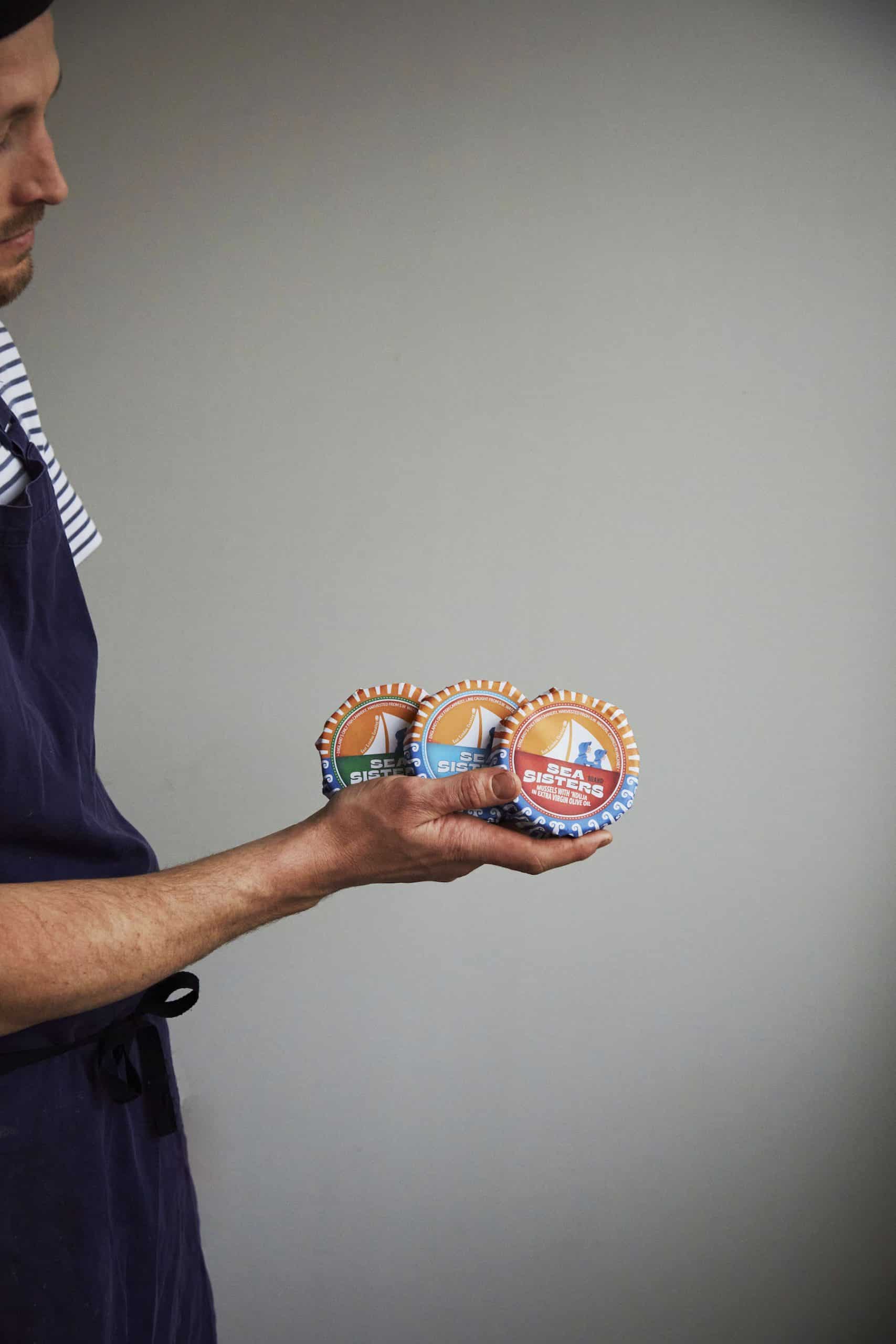 Angus holds cans from his East London Canning Co
